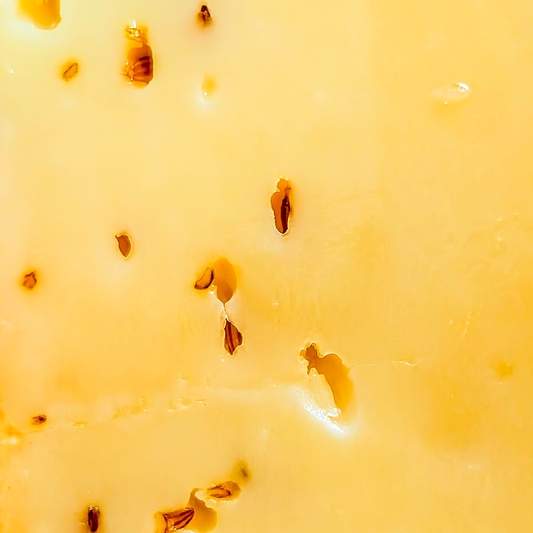 Baby Gouda Cumin cheese texture close-up